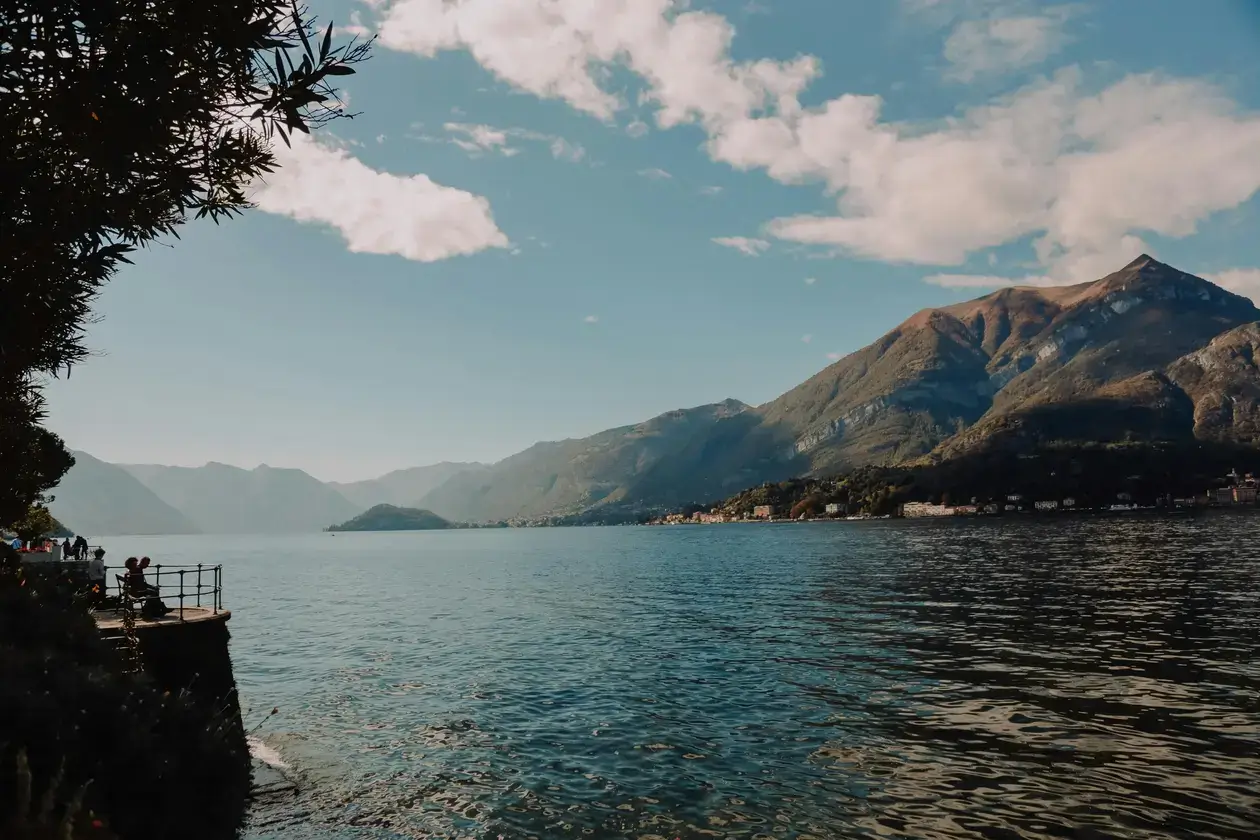Lake Como panoramic view with Alps in the background and blue water